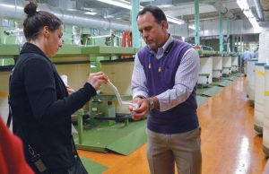 Jim Hopkins, director of sales, Hamrick Mills, demonstrated how twist turns sliver into a yarn with assistance from Dorota Arcentales, fabric manager, PVH Corp.