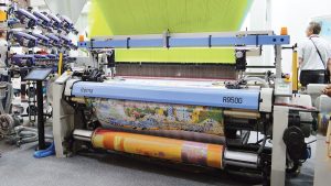 Stäubli demonstrated the capability of its jacquard weaving machines by producing intricately woven jacquard fabrics with a Barcelona-themed design.